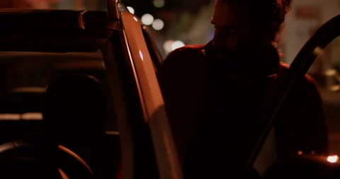 Pro surfer Hugo Vau getting in car with his wife Ines Vau in night time, Nazare Stock Footage 156031608
