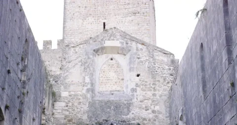 Pro surfer Nuno Santos playing violin in streets of old Leiria castle, Portugal Stock Footage 155262696