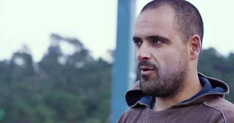 Pro surfer Nuno Santos talking about experience of playing violin while surfing Stock Footage 156630452