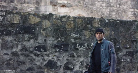 Pro surfer Nuno Santos walking talking about history of castle of Leiria Stock Footage 155258127
