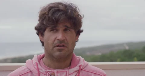 Pro surfer Rafael Tapia talking about trying his new surfboard in wavy ocean Stock Footage 158651292