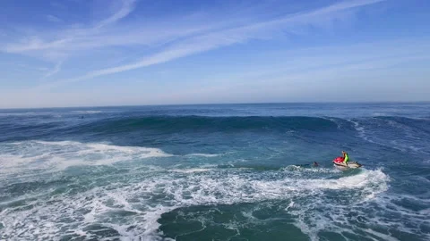 Pro surfer riding big waves and wake boarding in ocean in Nazare Stock Footage 151117403