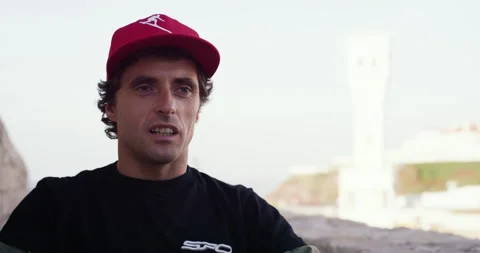Pro surfer Sergio Cosme talking about meeting new people in Red Chargers Stock Footage 156274464