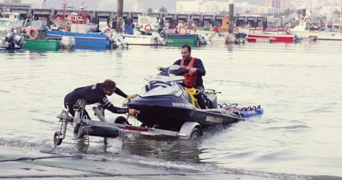 Pro surfer Vitor Faria and Rodrigo Koxa trying to dock jet ski on trailer Stock Footage 156629853