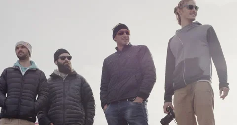 Pro surfers commenting on ocean waves during windy day Stock Footage 164320888