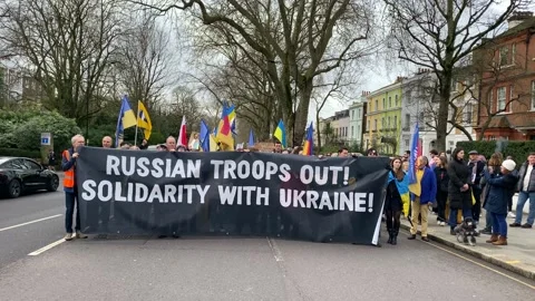 Pro Ukraine protesters at demonstration, march to the Russian Embassy in London. Stock Footage 303017292