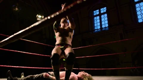 Pro Wrestling Match: Wrestler Slams Opponent & Standing Moonsault Backflip Stock Footage