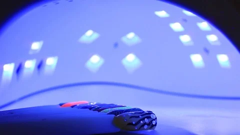 Probes, artificial nails under an ultraviolet lamp. Stock Footage 128123853