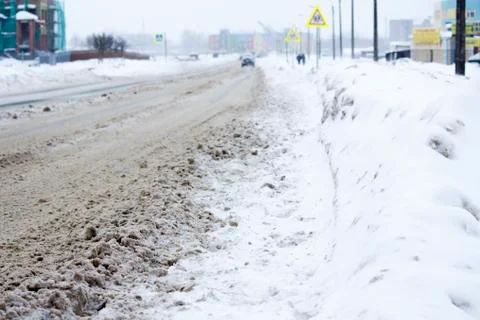 Problem after snowfall - snow on the city road, snow porridge Stock Photos