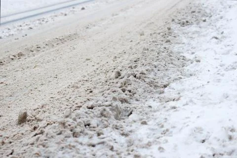 Problem after snowfall - snow on the city road, snow porridge Stock Photos
