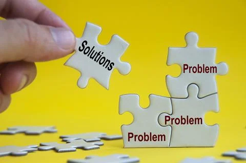Problem and solutions text on jigsaw with one hand holding a missing jigsaw.. Stock Photos