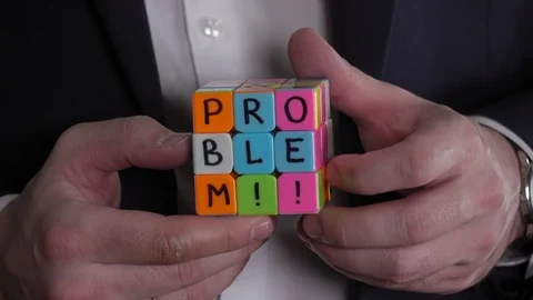 Problem and solve . Businessman hands solving Rubik's cube puzzle. Stock Footage 92541676