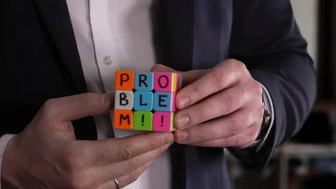 Problem and solve . Businessman hands solving Rubik's cube puzzle in the office. Stock-Footage 92542337