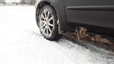 Problem of car&amp;#039;s wheel on the winter road. Driver tries to drive Stock Footage 328730552