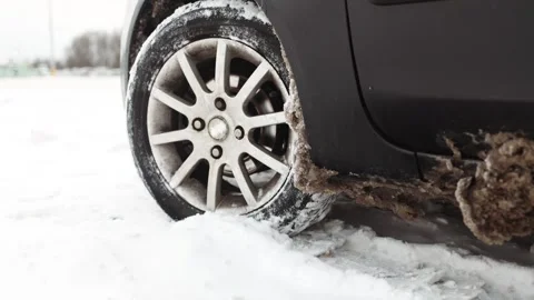 Problem of car&amp;#039;s wheel on the winter road. Driver tries to drive Stock Footage 328731647