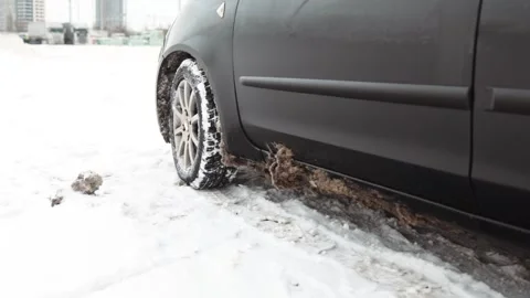 Problem of car&amp;#039;s wheel on the winter road. Driver tries to drive Stock Footage 328731704