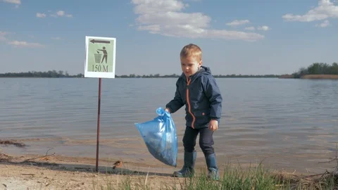 Problem ecological pollution litter in nature, portrait of little boy with Stock Footage 108170341