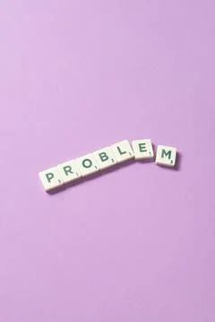 Problem formed of scrabble blocks on lilac background. Stock Photos