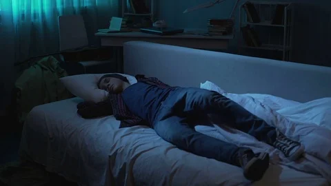Problem lazy young man going bed and sleeping after student party, tiredness Stock Footage 85165352