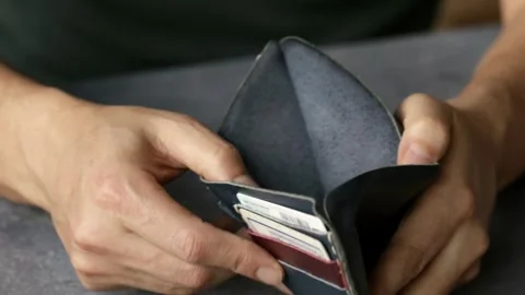 Problem person man holding and open empty wallet, purse no have money bill Video stock 336450443