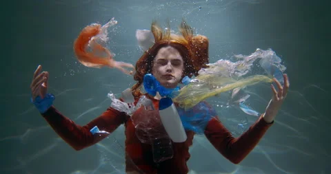 The problem of plastic. Cinematic shot of young woman spreading waste under Stock Footage 154384087