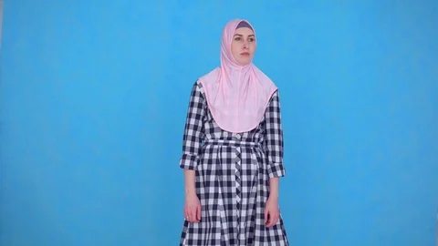 Problem is the smell of sweat, a young Muslim woman in hijab looking at the Stock Footage 107347952