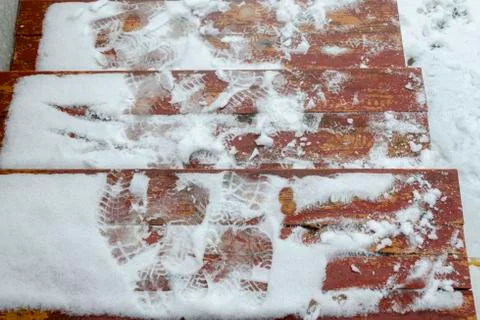 The problem of snow removal in the city. The steps are icy, covered with snow Stock Photos