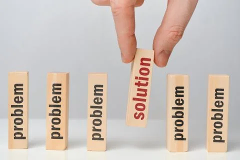 Problem solution concept - hand holds wooden block with the inscription. Stock Photos