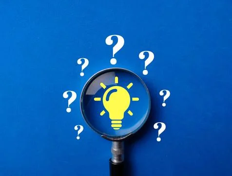 Problem solving concept.Magnifying glass focus on light bulb icon among question Fotos de archivo