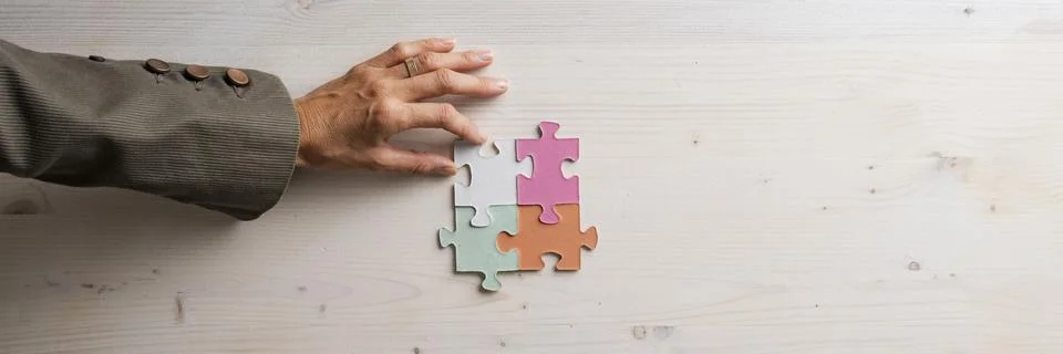Problem solving conceptual image with a hand completing a puzzle Stock Photos