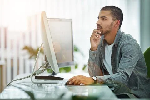 Problem solving is his specialty. Shot of a young designer working at his Foto stock
