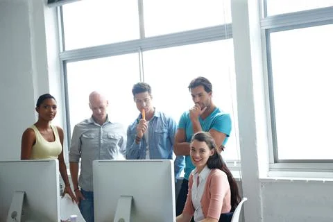 Problem solving is their pleasure. A group of designers standing in a office Foto stock