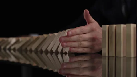 Problem Solving,Close up view on hand of business man stopping falling blocks on Stock Footage 246393233