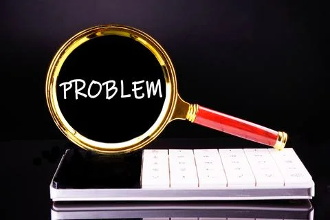 PROBLEM word written through a magnifying glass on a calculator on a black ba Stock Photos
