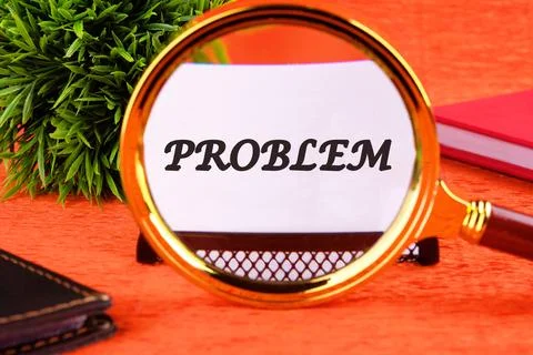 PROBLEM word written through a magnifying glass on a white business card on.. 스톡 사진