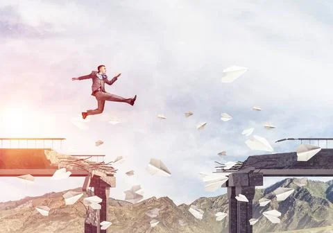 Problems and difficulties overcoming concept. Businessman jumping over gap... Stock Photos