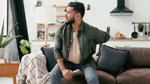 Problems with the back, spine, sciatica. Sad Arabian or Indian man, dressed in Video stock 204954454