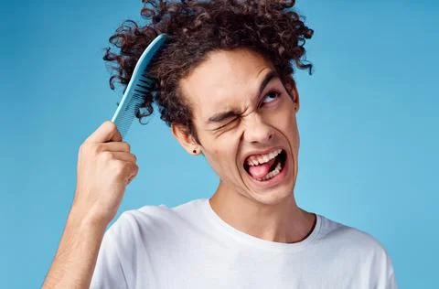 Problems with combing hair young guy in t-shirt and combing curls model Stock Photos