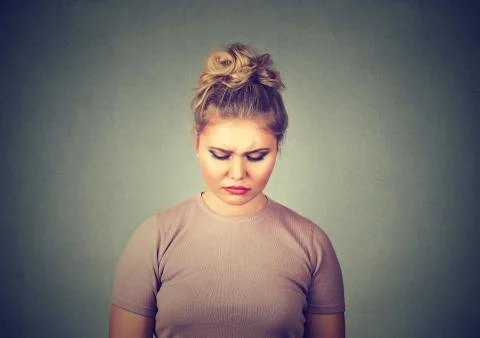 Problems. Sad woman looking down Stock Photos