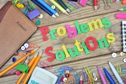Problems Solutions words and office tools on wooden table Photos