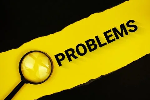 Problems text on yellow with black paper torn ripped and magnifying glass 写真素材