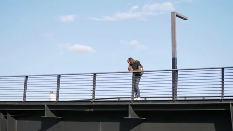 Problems, thoughts - young black student on the bridge with his head in his hand 스톡 동영상 143243002