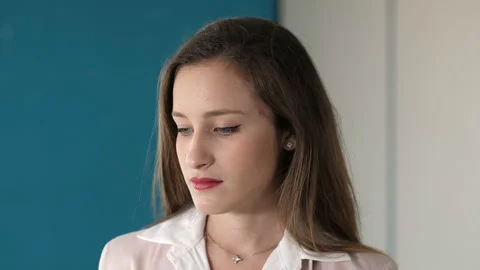 Problems at work - pensive female manager looks up and stares at the camera Stock Footage 149261377