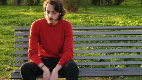 Problems, worries - thoughtful man at park thinks about how to solve a problem Stock Footage 147226074