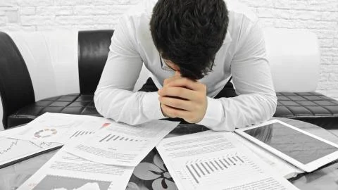 The problems young business man working at office with documents Stock Photos