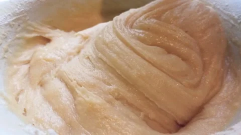Proccess of making shortbread dough for a pie, mixing with spoon. Horizontal 4k Stock Footage 290788525