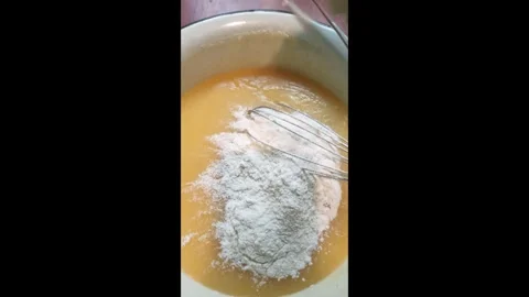 Proccess of making shortbread dough for a pie, mixing with whisk. Vertical 4k Stock Footage 292885184
