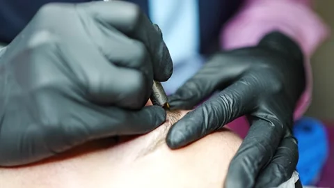 Procedure of eyebrow microblading. A master in black gloves is doing a blending Stock Footage 199962769