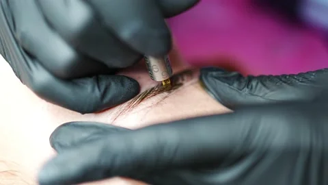 Procedure of eyebrow microblading. A master in black gloves is doing a blending Stock Footage 201367386