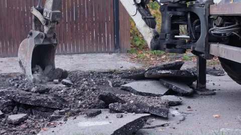 The procedure involved in the asphalt removal process during construction work Stock-Footage 312439548